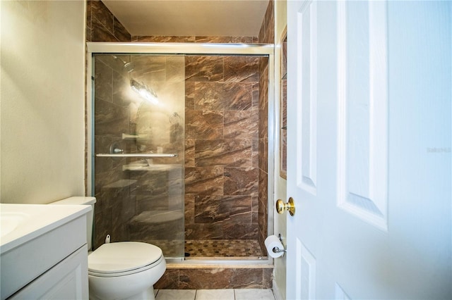 bathroom with vanity, toilet, and a shower with door