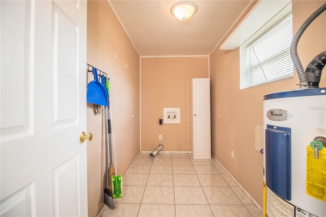 clothes washing area featuring crown molding, water heater, and light tile patterned floors