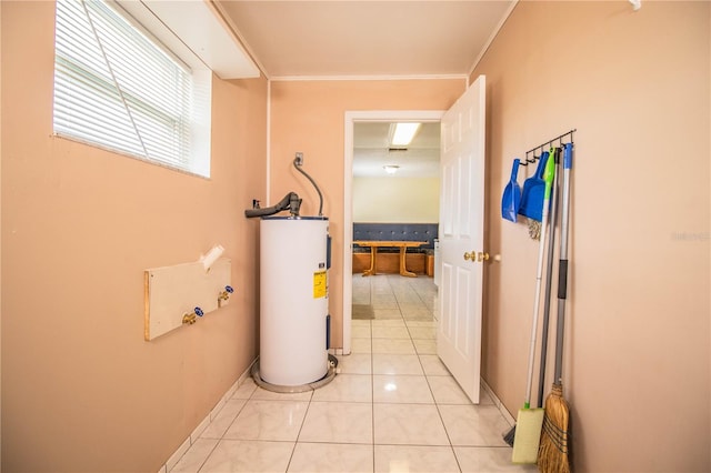 hall with crown molding, electric water heater, and light tile patterned flooring