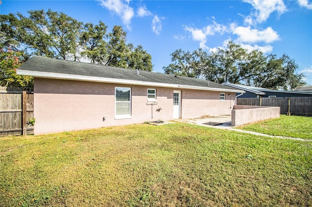 back of property featuring a lawn