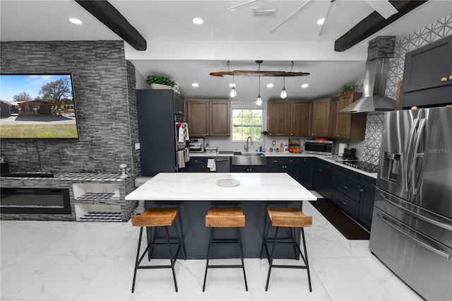 kitchen with tasteful backsplash, beamed ceiling, a kitchen island, exhaust hood, and appliances with stainless steel finishes