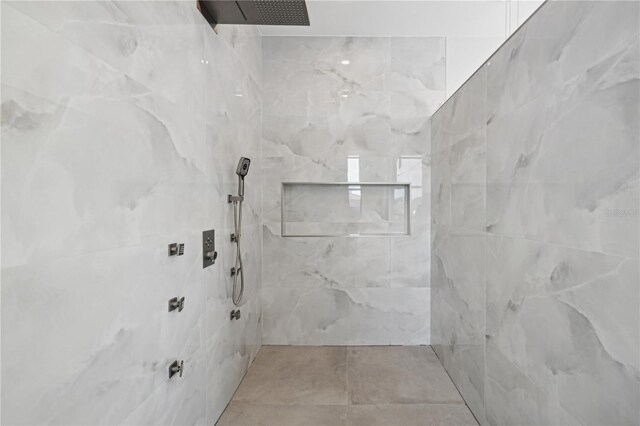 bathroom featuring a marble finish shower
