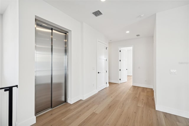 corridor featuring light hardwood / wood-style floors