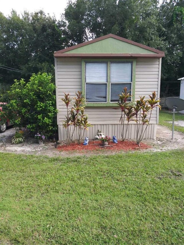 view of side of home with a lawn