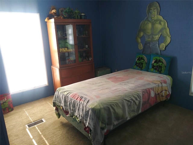 carpeted bedroom featuring visible vents