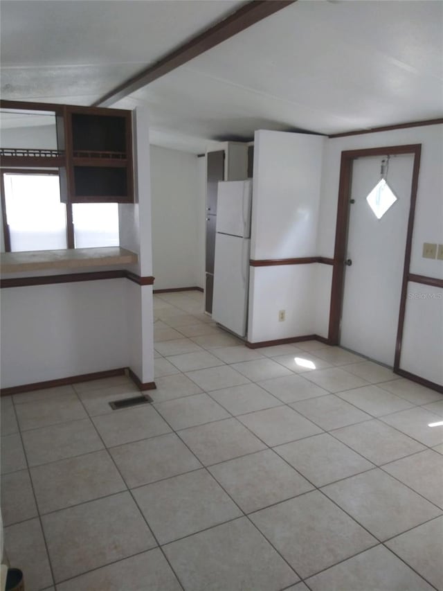 interior space with light tile patterned floors, a wealth of natural light, visible vents, and baseboards