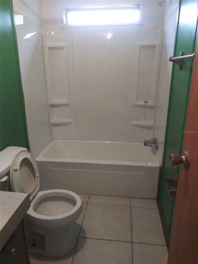 bathroom featuring tile patterned floors, vanity, shower / tub combination, and toilet
