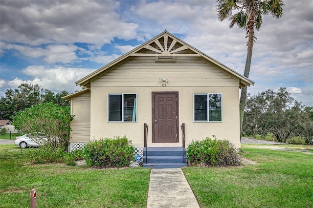 bungalow-style home featuring a front yard