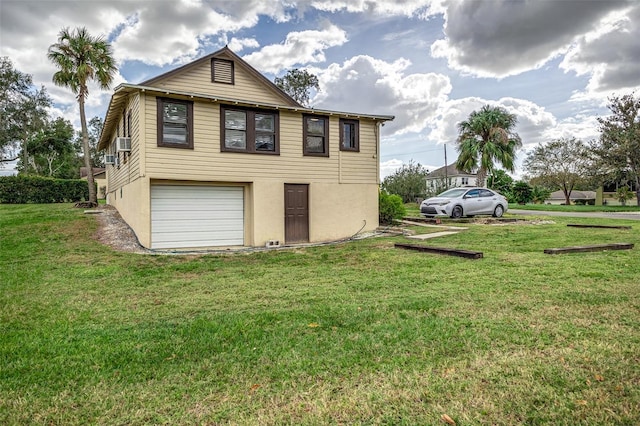 view of home's exterior with a yard, cooling unit, and a garage