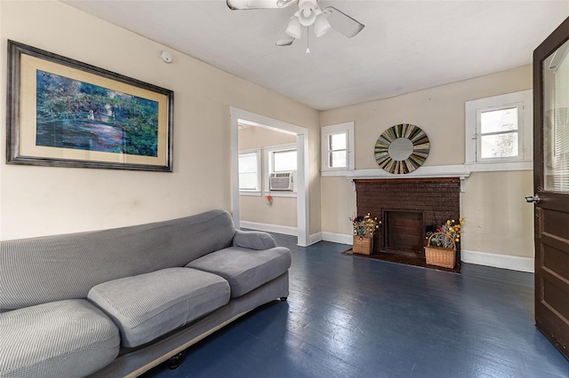 living room with ceiling fan, a wealth of natural light, a brick fireplace, and dark hardwood / wood-style flooring