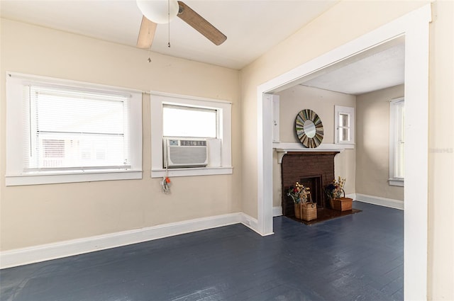 living room featuring dark wood-type flooring, cooling unit, a brick fireplace, and ceiling fan