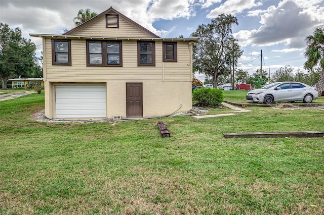 view of home's exterior with a yard and a garage