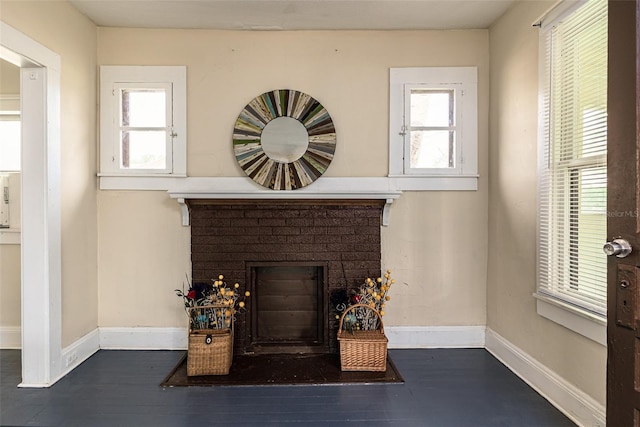 interior details featuring hardwood / wood-style flooring and a brick fireplace