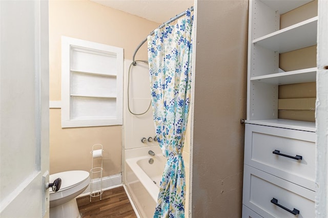 bathroom featuring toilet, wood-type flooring, and shower / tub combo