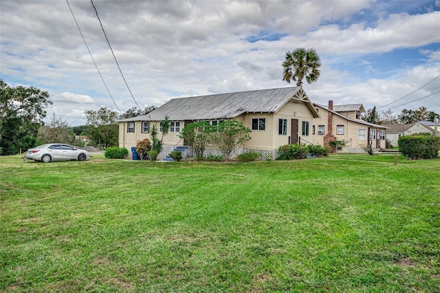 view of side of property with a yard