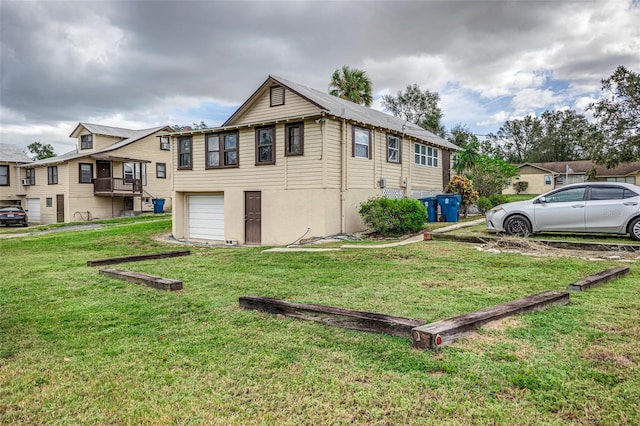 view of home's exterior featuring a lawn and a garage