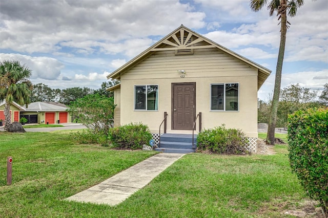 bungalow-style home featuring a front yard and a garage