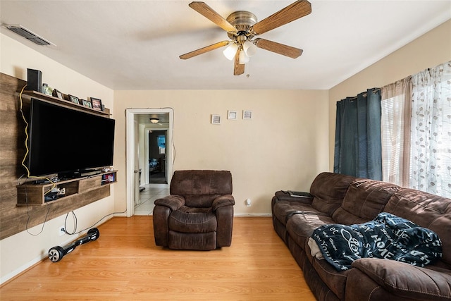 living room featuring light wood-type flooring and ceiling fan