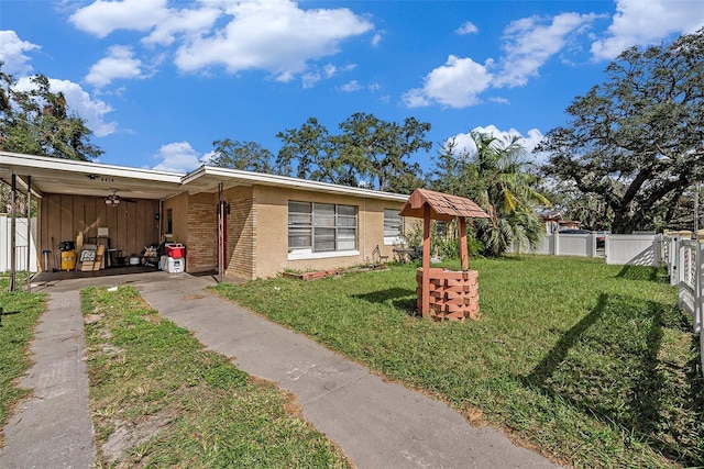 view of front of home featuring a front lawn and a carport