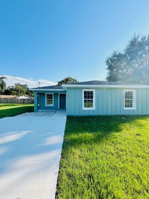 single story home with a patio and a front yard