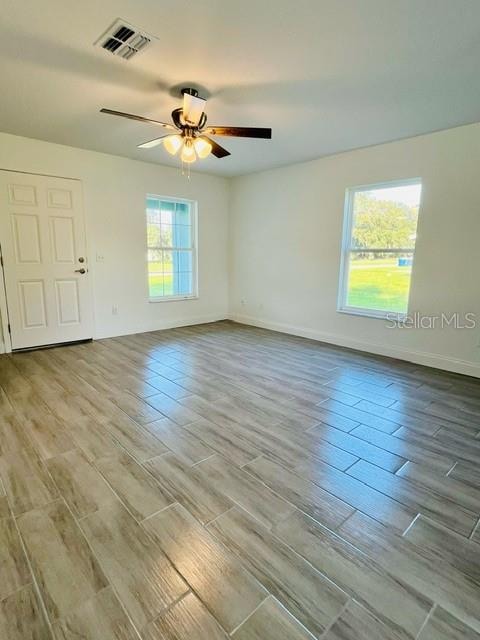 unfurnished room featuring light hardwood / wood-style floors and ceiling fan