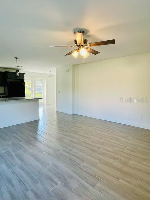 unfurnished living room with ceiling fan and light hardwood / wood-style floors