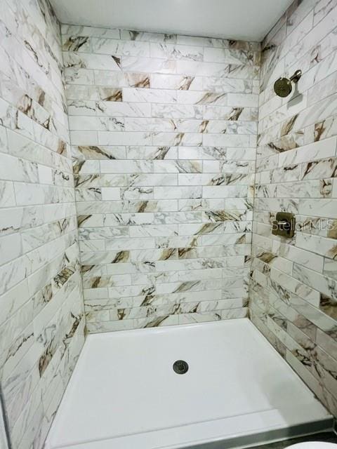 bathroom with a tile shower