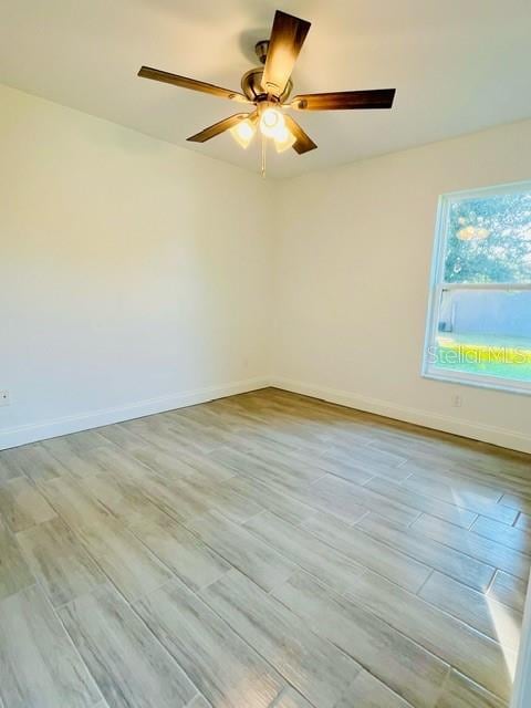 spare room featuring light wood-type flooring and ceiling fan