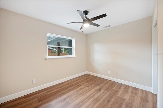 empty room with light wood-type flooring and ceiling fan