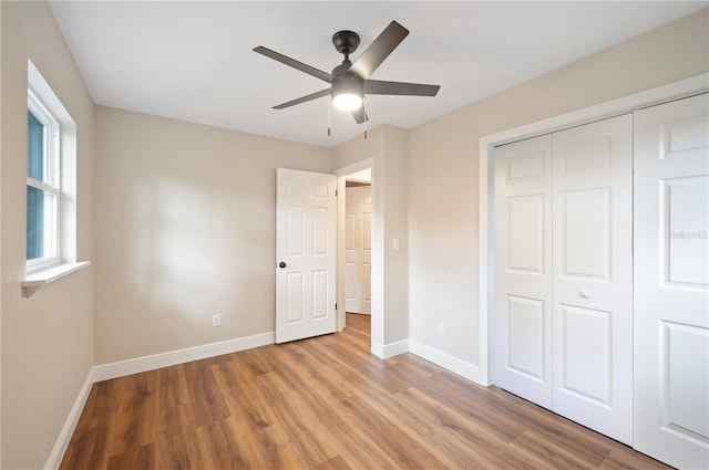 unfurnished bedroom with ceiling fan, light hardwood / wood-style flooring, and a closet