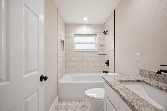 full bathroom featuring vanity, tile patterned flooring, toilet, and tiled shower / bath