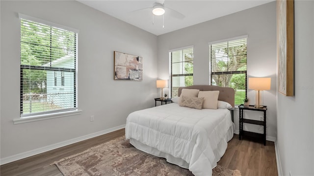 bedroom with ceiling fan and dark wood-type flooring