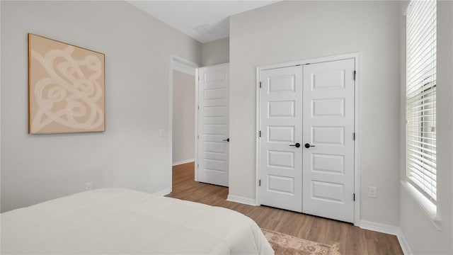 bedroom with a closet and light wood-type flooring