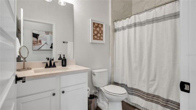 bathroom featuring vanity, toilet, and a shower with curtain