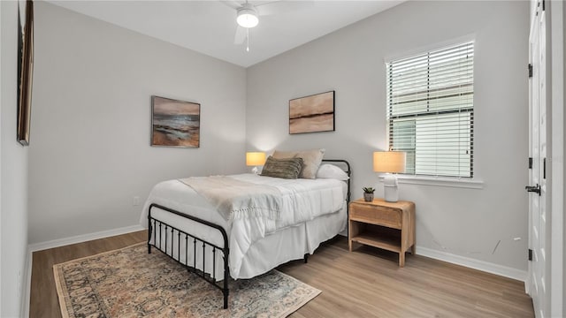 bedroom with light wood-type flooring and ceiling fan