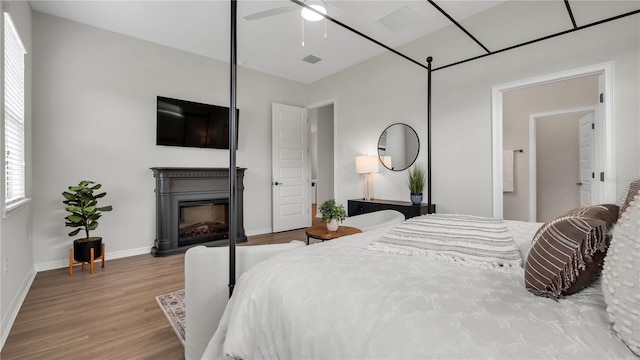 bedroom with ceiling fan and hardwood / wood-style floors