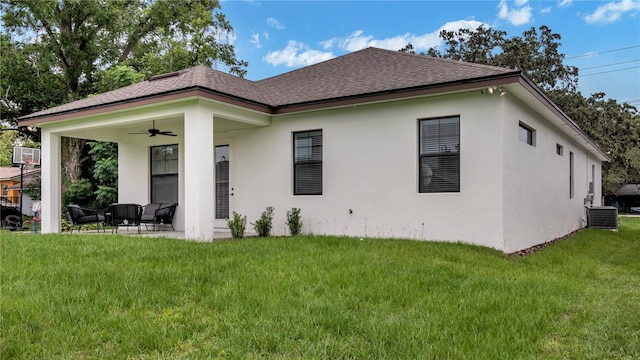 rear view of house with a patio, a yard, cooling unit, and ceiling fan