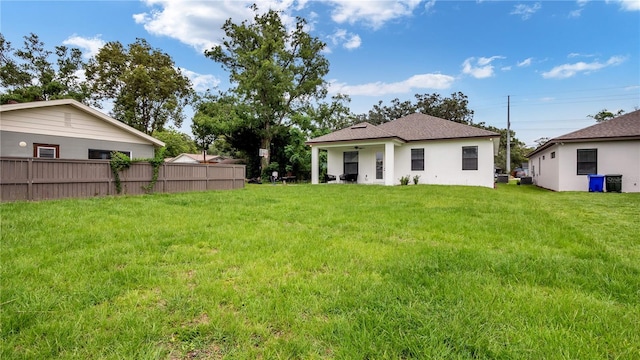 back of property featuring a yard