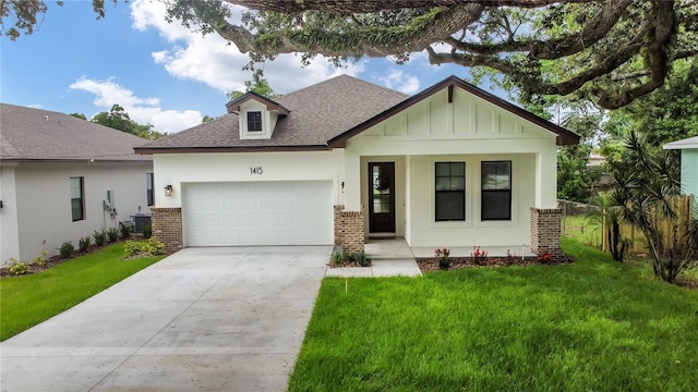 view of front of home featuring a front yard, a garage, and central air condition unit