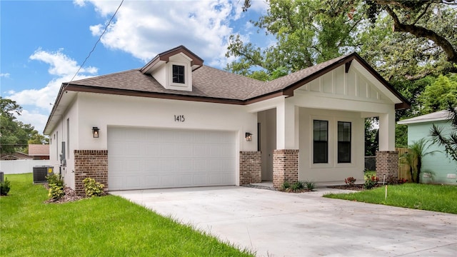 view of front of house with a garage, a front lawn, and central air condition unit