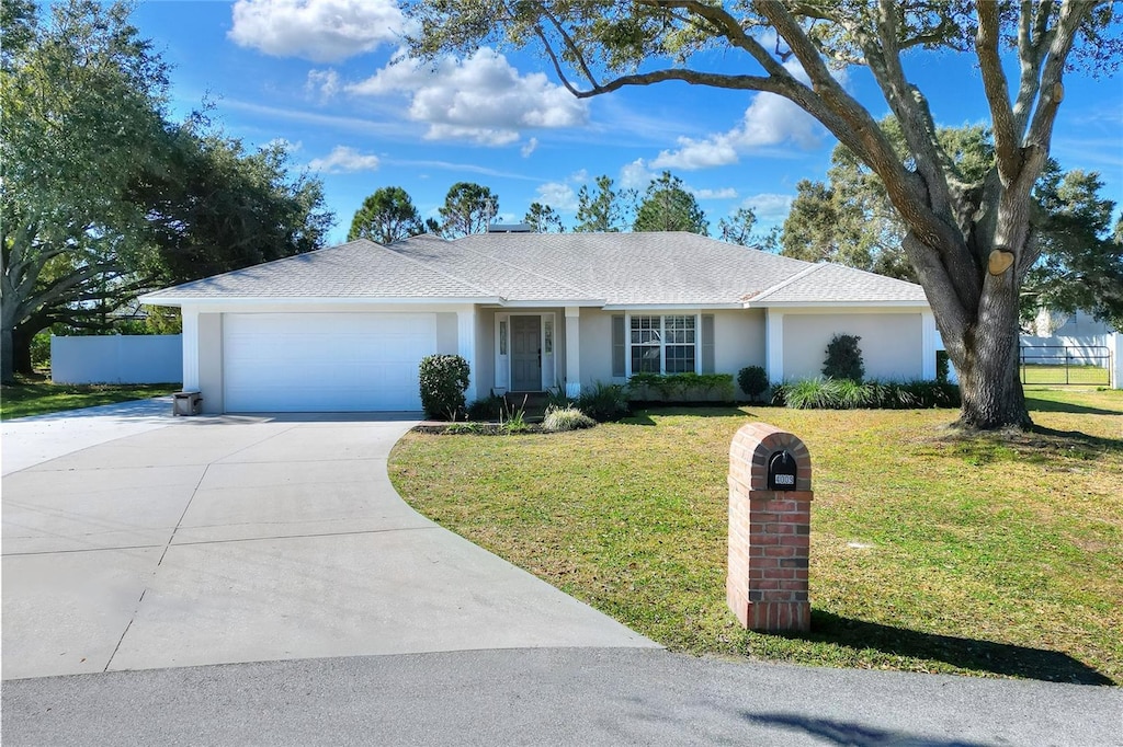 ranch-style home with a front lawn and a garage