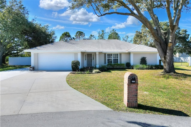 ranch-style home with a front lawn and a garage