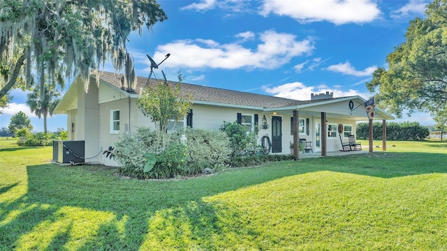 rear view of house with a yard, a patio, and central air condition unit