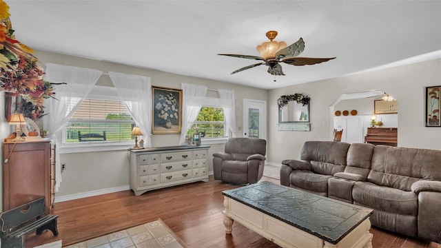 living room with ceiling fan and hardwood / wood-style floors