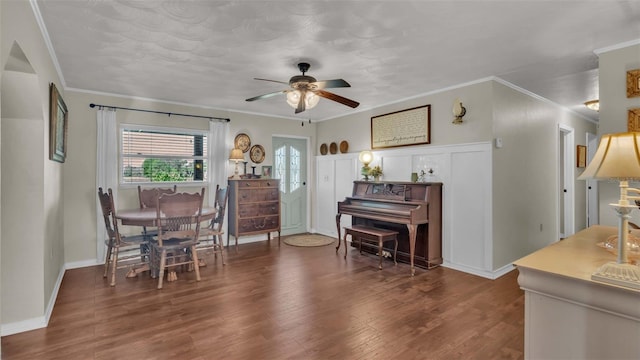 dining area with ceiling fan, dark hardwood / wood-style floors, and ornamental molding