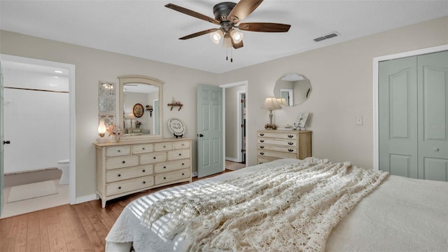 bedroom with hardwood / wood-style floors, a closet, ensuite bathroom, and ceiling fan