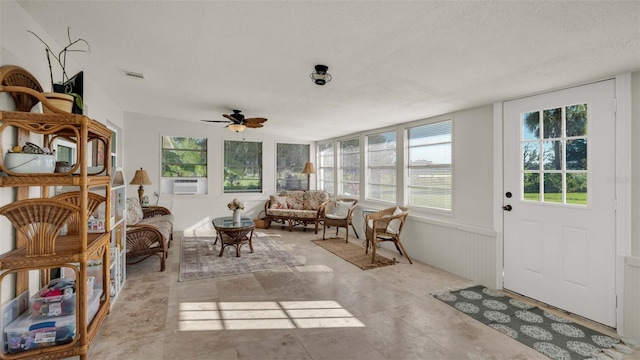 sunroom featuring ceiling fan and cooling unit