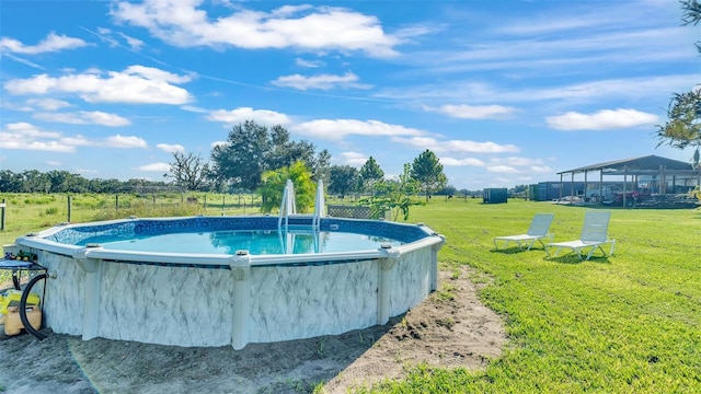 view of swimming pool with a lawn