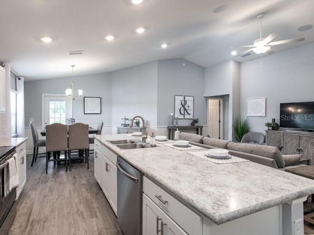 kitchen with light wood-type flooring, vaulted ceiling, dishwasher, hanging light fixtures, and white cabinets