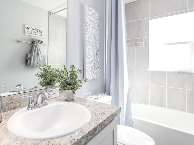 full bathroom featuring vanity, toilet, and shower / bath combo